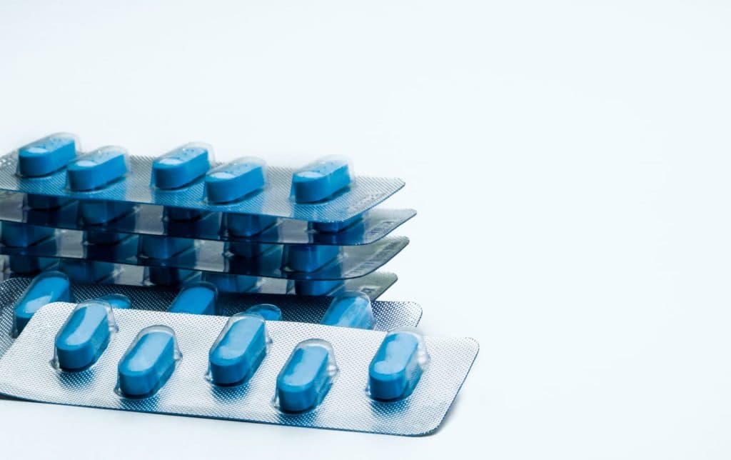 Blue antiviral tablets laid out as a full course of herpes treatment
