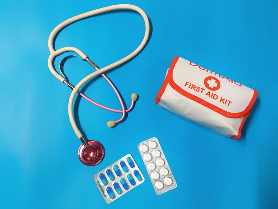 A stethoscope, a first aid kit pouch and two blister packs of tablets on a blue background